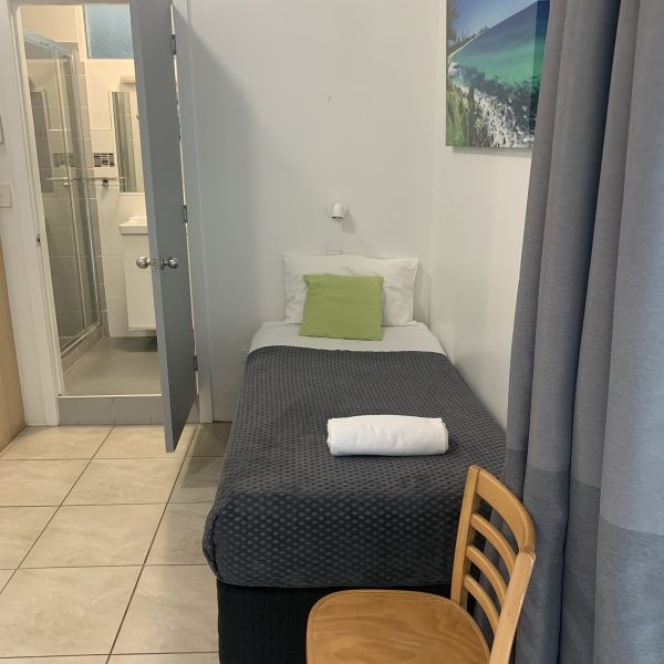room with a single bed and bathroom